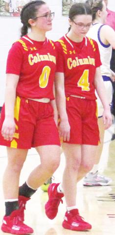 Sisters Katy Mooney, freshman and Lily Mooney, senior, walk off the court for the last time as teammates after the heartbreaking Lady Titan Sub-State loss to Neodesha, 47-52, Saturday in Fredonia.