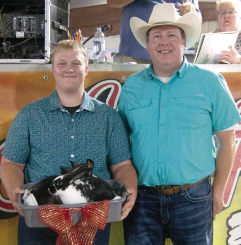 Glittering Stones 4-H member Joshua Brown, son of David and Serena Brown, showed the Grand Champion Rabbit colony and received a premium of $2,000 from Rainbow Solar.