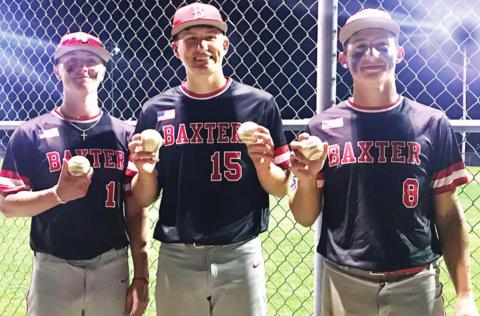 Baxter Springs Lions hitters, Kameron Williamson, Riley Bush and Kaden Niday display their home run balls, a grand slam for Niday, as the Lions clinch the CNC League Title with a sweep of the Bulldogs, 22-5 and 11-3, in Galena, Thursday Night. Photo by Dee Riley.