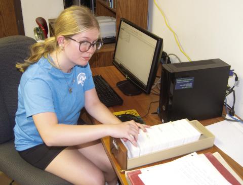 Riverton High School Junior Kaylee Knowlin is working as a volunteer at the Columbus Clione Bieber Genealogical Library of Family History during this summer. She is currently typing the obituary card catalog into the computer so the information will be online in the future.