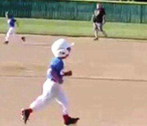 Five year-old Kason Pitts runs to first base after hitting a hard ground ball at the Field of Dreams in Baxter Springs. Photo by Dee Riley.