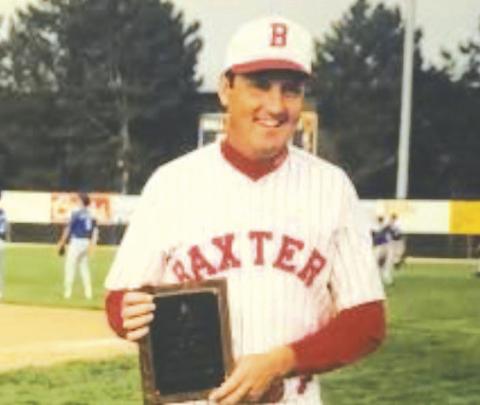 Don Karnes at a state baseball tournament with one of his many awards. Courtesy photo.