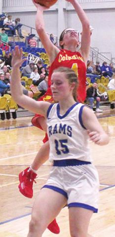 Lady Titan Senior, Lily Mooney, goes up for a lay up over Lady Ram Junior, Morgan Compton following a steal and full court drive during the Columbus 31-28 win at Riverton, Friday. Lily led all scoring with 14 points on the night.