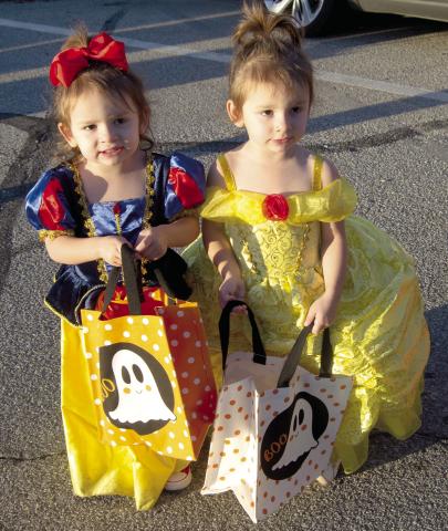 Fletcher and Baker Burns were dressed as Disney© princesses at the Trick or Trunk held Monday night on the Columbus Square.