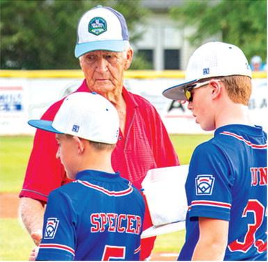 Reigning Kansas Little League Baseball District 2 Administrator, Wayne Metcalf, hands out awards to teams competing in the Kansas State Little League Championship Tournament in Baxter Springs, July 24-25. The Pittsburg JL Hutchinson League All-Stars won the 11-12 year-old division over The JOCO Navy (Royals Amateur Development System) in a close bestof- three series hosted by the Baxter Springs Little League at Wayne Metcalf Field.