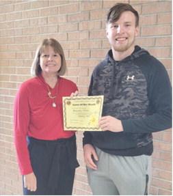 Brandon Stice was named Columbus Lion of the-Month for January. Regina Jameson is shown presenting the certificate. Courtesy photo.