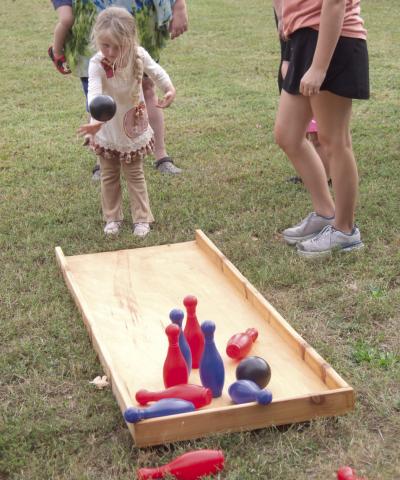 Lawn bowling can be intimidating for youngsters such as Abagale Harvey as she does her best to knock down the pins. The game was one of many games at Scammon Fall Festival.