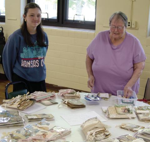 The 13th annual scrap book day at St. Bridgets in Scammon had more than 55 participants. During the session Saturday morning Laryn Keller and her grand mother Marilyn Keller taught a class on book binding the scrap books.