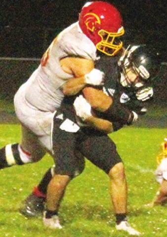 Titan Senior, Kody Schalk, takes down the Raider ball carrier deep in the backfield during the Columbus loss in Frontenac, 26-6, Friday.