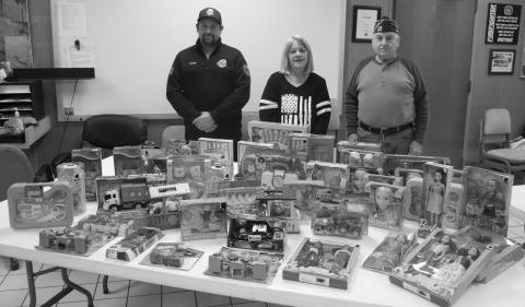 The Columbus VFW Auxiliary donated toys to the Columbus Fire Department Shop with a fireman campaign. Firefighter Juston Grafel accepted the toys for the Columbus Fire Department. Peggy Britt president of the VFW Auxiliary gave the toys to the Fire Department because they were no longer have their kids Christmas Party. Jim Oberbeck Commander of the Columbus VFW Post attended the exchange.