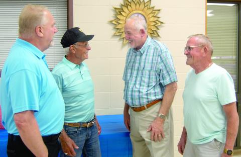 Executives with the United Mine Workers Union met briefly during the 26th annual retirees dinner held in Pittsburg Saturday evening. International Representative of District 12 Tim Miller chats with Pittsburg Local President Jim Lovell, International District 12