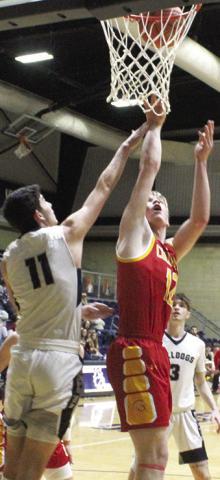 Galena Senior, Hadley Price, fouls Titan Junior, Cole Youngblood, on his shot for a Columbus and-one in the 40-47 loss to the Bulldogs in Galena, Tuesday. Cole led the Titans with 12 points off the bench.