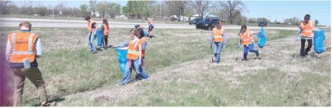 Southeast seventh grade students participated in a day of service April 8. Groups picked up trash along Highway 7 and cleaned headstones in the Cherokee Cemetery and completed other grounds maintenance. Courtesy photo.