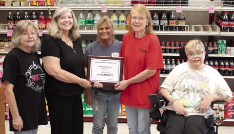 In recognition of their community impact in employing qualified persons with disabilities, SKIL Independent Living Advocate Jeanette Graham, SKIL President and CEO Shari Coatney and Tara Frasier (far right) also a SKIL Independent Living Advocate, present an award to the Columbus Apple Market. Apple Market assistant manager Kristy Jameson and manager Candy Phillips received the award on behalf of the store.
