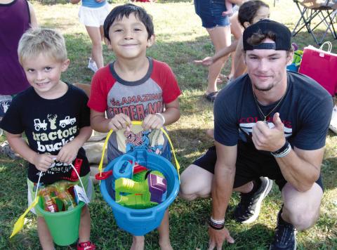 In Saturday’s Freedom Fest, sponsored by the Columbus Fire Department, Craighton Duley and Oliver Siemer won the boys under six years old sack race competition. Firefighter Austin Hoiser presented the prizes.