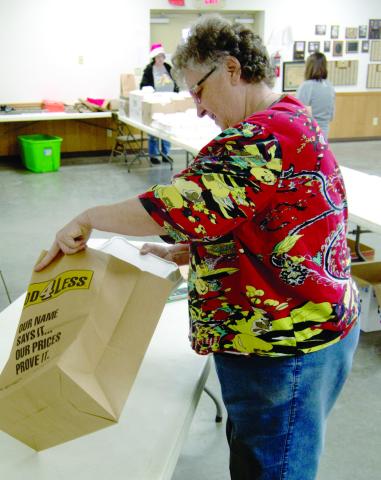 Long time coordinator of the Community Christmas dinner, Robin Jones, packed the to go orders for delivery.