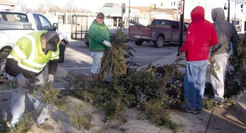 Members of the Columbus Lions Club spent New Years Day afternoon sawing-up and hauling away the Christmas tree which they placed in front of the Courthouse a month earlier. This was the ninth year the Lions Club had placed the tree behind the fountain.