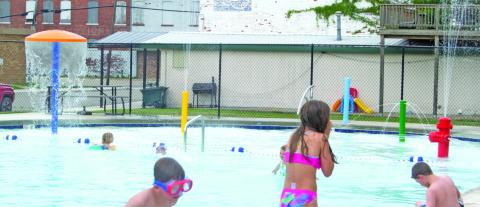 Youngsters were ready for the Scammon pool to open Saturday as they turned out for the event which was suddenly dampened by a short rain. New features in the kiddy pool have been added.