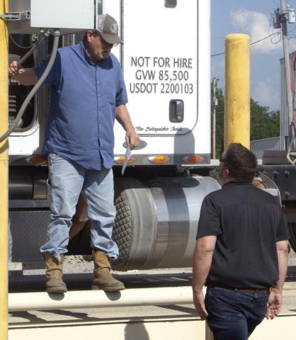 Fouts Farms Grain truck driver gives his burger order to Chamber Past President Matt Case. During the Chamber of Commerce Feed the Farmers semiannual program.