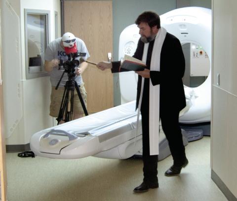 Father Jeremy Huser was at the Columbus Mercy Hospital to bless the newly installed CT machine. The staff has been trained to operate the equipment.