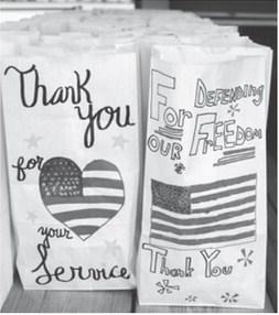 Last year local students decorated the sacks used to pack the lunches for veterans and first responders. This year the event will be a drive through event at the Lions Shack.