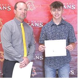 Jensen Hale, CUHS Senior, received a scholarship from Northeastern Oklahoma A&amp;M College during the 2026 Senior Assembly at the Columbus High School Gymnasium. Presenting the scholarship was Jerry Smiley, USD 493 instructor.