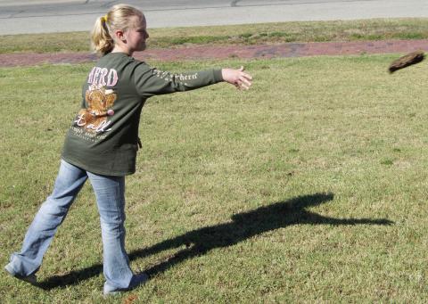 Some new events were held at the museum during the Columbus Day Festival. One of those events was the cow patty tossing contest. Ryleigh Holmes makes her best toss.