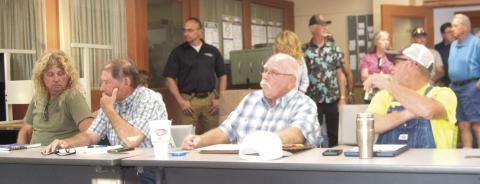 Planning Commissioners Roger Draeger, John Lopp, Randy Commons, and Scott Boyes are surrounded by the community members attending the meeting.