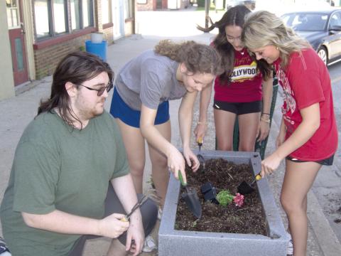 Members of Columbus High School National Honor Society filled area planters with flowers before the end of the school year. Those helping included Robert Graham III, Ruby Stover, Faith Williams and Kenadie Carter.