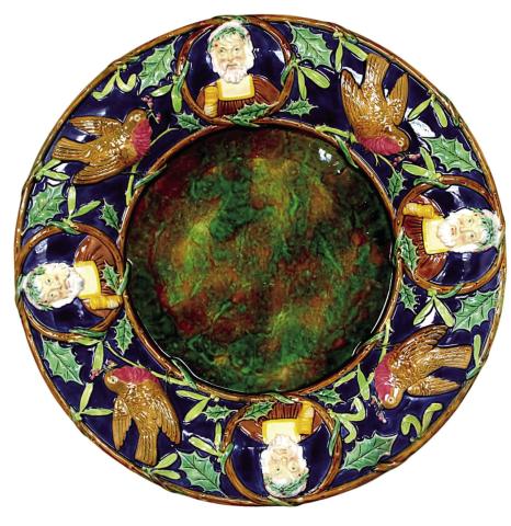 Victorian English majolica maker George Jones decorated this platter with English Christmas symbols that may be unfamiliar to Americans, but still have the spirit of the holiday. Photo Credit: Strawser Auction Group (c) 2024 by Cowles Syndicate Inc
