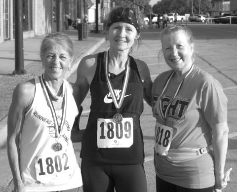 In the female over 60 division of the Columbus Days 5K run Turia Smith, West Mineral, (center) took first place honors with a time of 27.54. Kathy Richart, Carthage, Missouri, was second (at left) with a time of 28:06 and (at right) Phyllis Kelly was third with a time of 35:35.