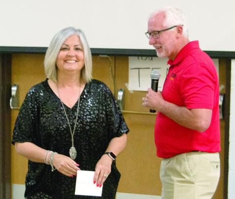 Superintendent Dr. Brian Smith recognized the retiring teacher Shari Napier, during the recognition breakfast on Friday. He noted that he and Shari had been in school together before she taught for 36 years in the local district.