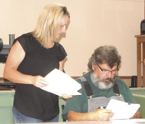 Cherokee County Planning Commission Secretary Lorie Johnson discusses the business before the meeting with Commission President Brett Warstler. The planners meet each month to prepare a comprehensive plan for regulation of land use.