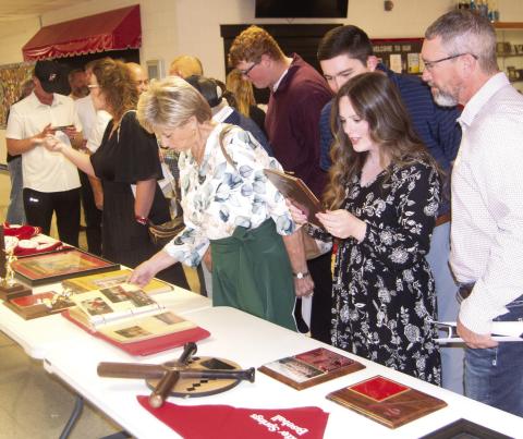 Former athletes and Baxter Springs High School students sorted through the memorabilia from the past. Everyone appeared to find something that they remembered from their high school days. Much of the material was from the personal collection of baseball coach Don Karnes.