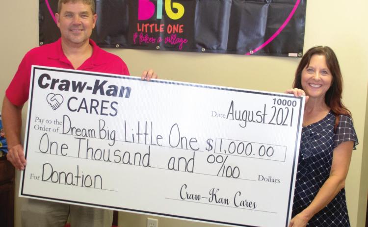 Local organization Dream Big Little One was presented a check for $1,000 to purchase beds and bedding for needy children. Tess Watson accepted the check presented by Zach Adams, CSR Manager on behalf of CrawKan CARES.
