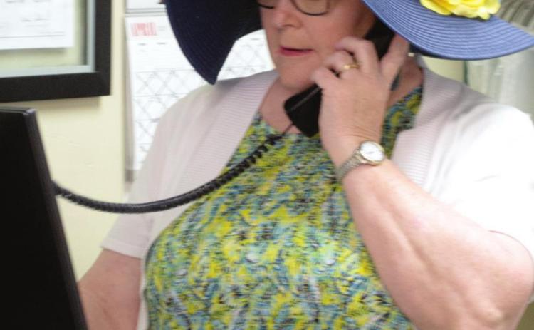 Linda Evans talks with a customer
