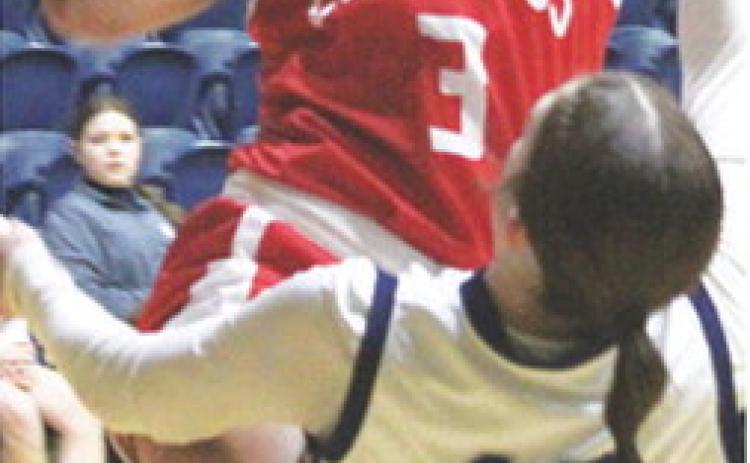 Lady Titan Senior, Brylie Johnson, goes up for two and gets an old-fashioned three on a foul by junior, Morgan Strong. Brylie finished with 15 points for Columbus in their, 43-37, win at Galena, Tuesday.