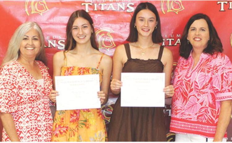 Darcy Garrett and Piper Hayes, seniors, received the Columbus Public Library Scholarship in the amount of $500 each from Shari Napier and Jennifer Thompson, Library Board Members during the Columbus Unified High School Senior Assembly, May 15 at the CUHS Gymnasium.