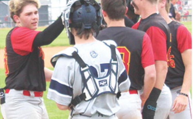 Kash Smith, Titan Freshman, is congratulated at home plate by his teammates following his third inning, base clearing, home run in his first varsity start for the Titans. The hit was Kash’s second grand slam of the game, tying a state record for most grand slams in one game. A single in the fourth inning gave Smith a total of nine Runs-Batted-In in the 14-1 win over the Bulldogs in Galena, Monday. Columbus completed the sweep with a 10-0 win in game two.