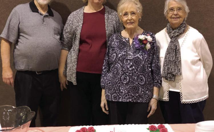 A come and go celebration was held Saturday in honor of the 90th birthday of Donna Lyerla (second from right). Bill Holden, Cathy Holden and Melissa Mc-Cool helped with decorations and adorning the table. Lyerla is a former Columbus resident and was a music teacher for a number of years. Courtesy photo.