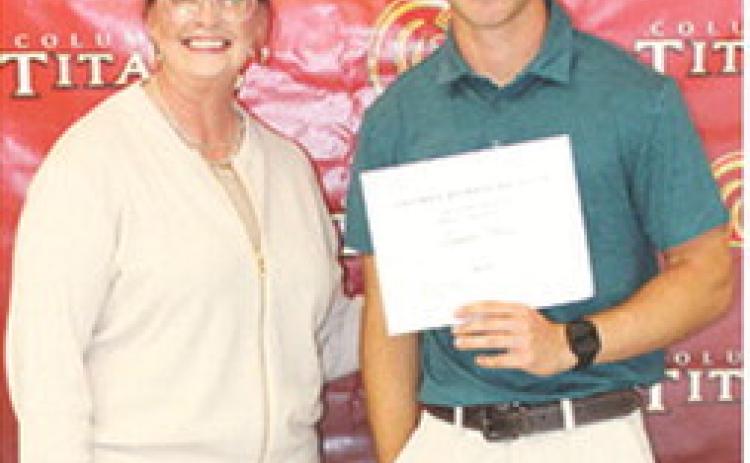 CUHS Senior, Lemmie Stone, received the Columbus Alumni Scholarship for $600 from Rebecca Spooner during the May 15 Senior Assembly at the Columbus Unified High School Gymnasium.