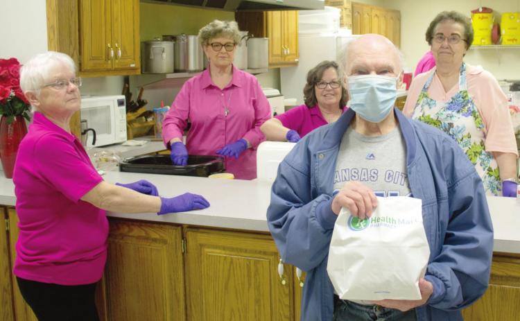 Columbus Mercy Hospital Auxiliary completed another successful pulled pork sandwich fundraiser despite changes being forced by the COVID pandemic. Several of the members recalled their days as car hops as they delivered the sandwiches to the cars. Working at the event were Edyth Tincknell, JaneAnn Turner, Janie Jarrett and LaDonna Smith. The customer was Gene Rockers.