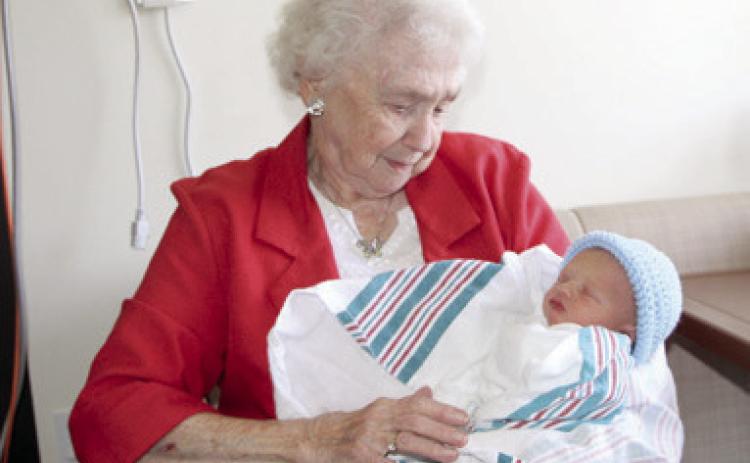 Columbus resident Ruby Wright, 90, has knitted over 1,000 caps for NICU babies at Freeman Hospital West in Joplin, Mo. She had the opportunity to hold Truett Percival, one of the recipients of her caps. Courtesy photo.