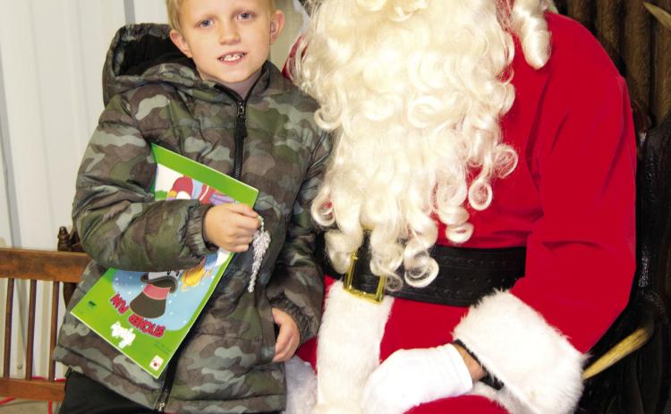 During the Columbus Museum open house Santa arrived to visit with the kiddies. Braden Pease talked to Santa about the upcoming holiday and explained how he was a good boy all year.