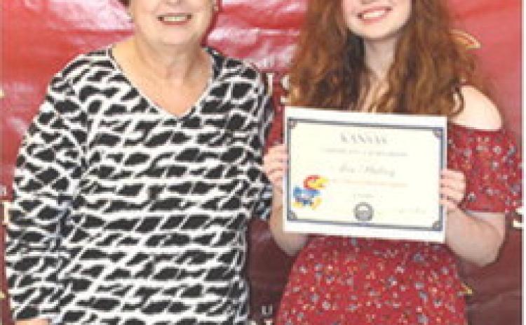 Senior Ava Hulvey received a $20,000 University of Kansas Chancellor Scholarship from CUHS Instructor, Karen Langerot, during the 2026 Senior Assembly at the Columbus Unified High School Gymnasium, May 15.