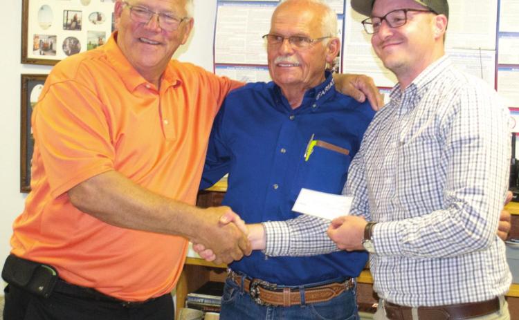 The Big Brutus director Jim Lovell and manager Joe Manns accepted a check for over $8,000 from Big Iron Overland Rally director Chris Holloway for the Big Brutus paint fund. The event had 16 hours of music, eight education classes for outdoor camping and was covered by nine news sources.