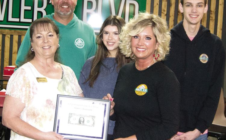 Operators of Bowlers Blvd in Columbus, Chris and Amy Johnson received their first dollar certificate from Chamber board member Sonja Duley during a ribbon cutting for the new member. Also pictured are Manager Allie Smith and Chris and Amy’s son Seth Johnson.
