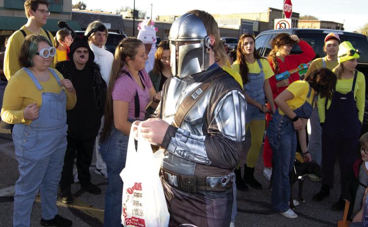 Dressed as Mandalorian, this trick or treater passed by the Columbus High School Band booth during the Trick or Trunk held Monday on the Square. Many of the band members dressed as Minions for the occasion.