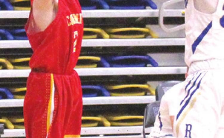 Titan Freshman, Luke Gray, shoots one of his three, three-point shots in the Columbus C Team win over Riverton, 30-20, Tuesday in Riverton. Gray had 11 points to lead the Titans in scoring. Ram Freshman, Noah Harper, defends.