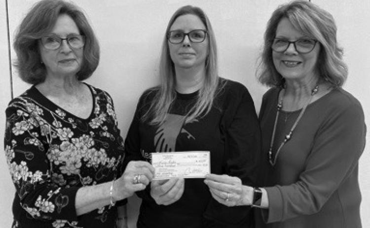 Parsons PEO member Janie Barcus and PEO president Debra Shaw present annual scholarship to Karie Leslie.